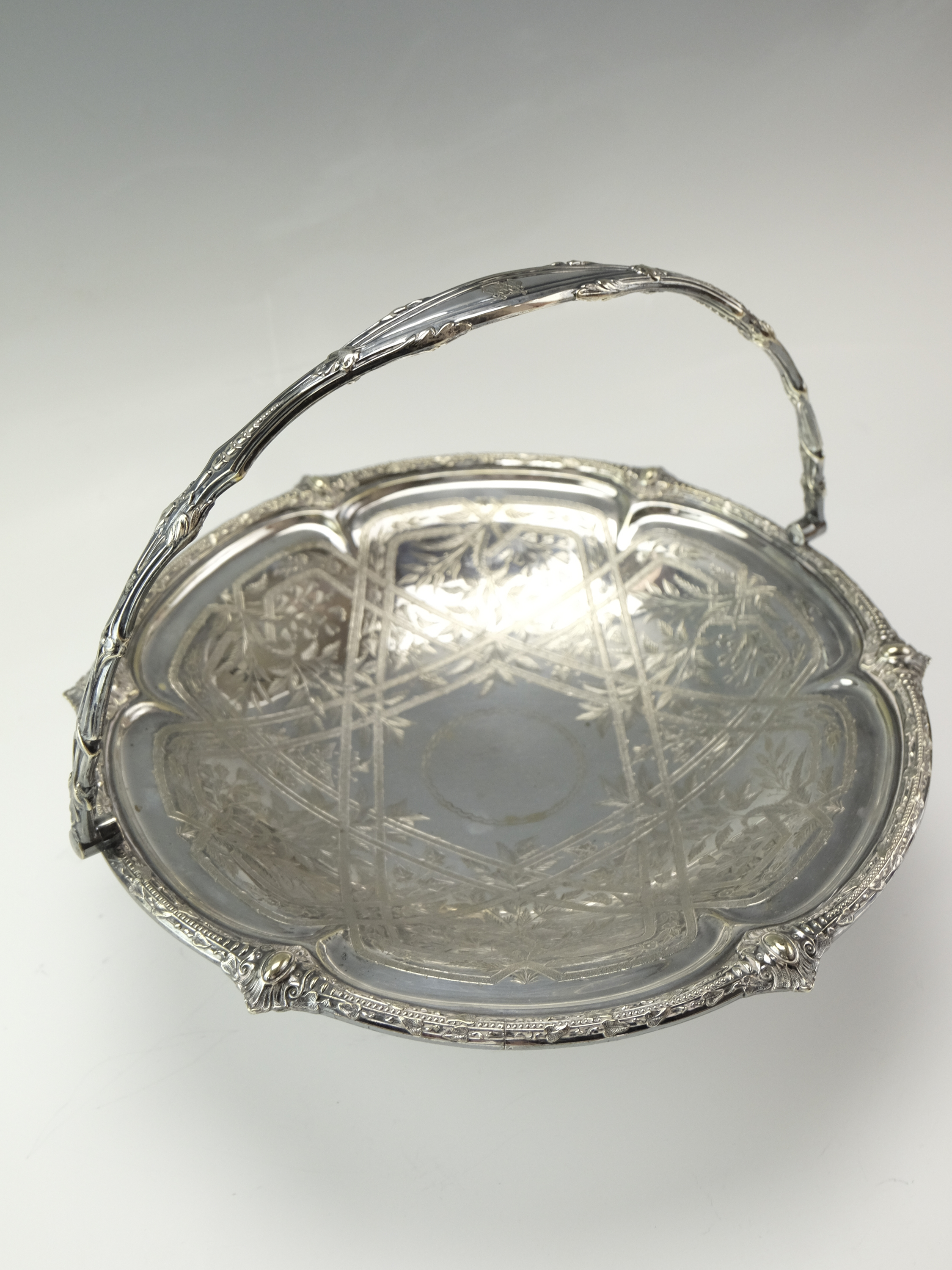 A late 19th Century electroplate swing handled cake basket having engraved decoration, 30 cm - Image 2 of 4