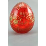 A late 20th Century Faberge ruby glass egg, having gilt wheel engraved decoration, 9 cm