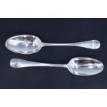 Two George II silver Hanoverian pattern table spoons, respectively bearing an engraved monogram, and