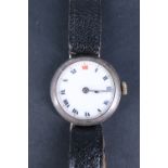 A 1913 silver wristlet watch, having an un-named Swiss movement and enamel face with "red XII" and