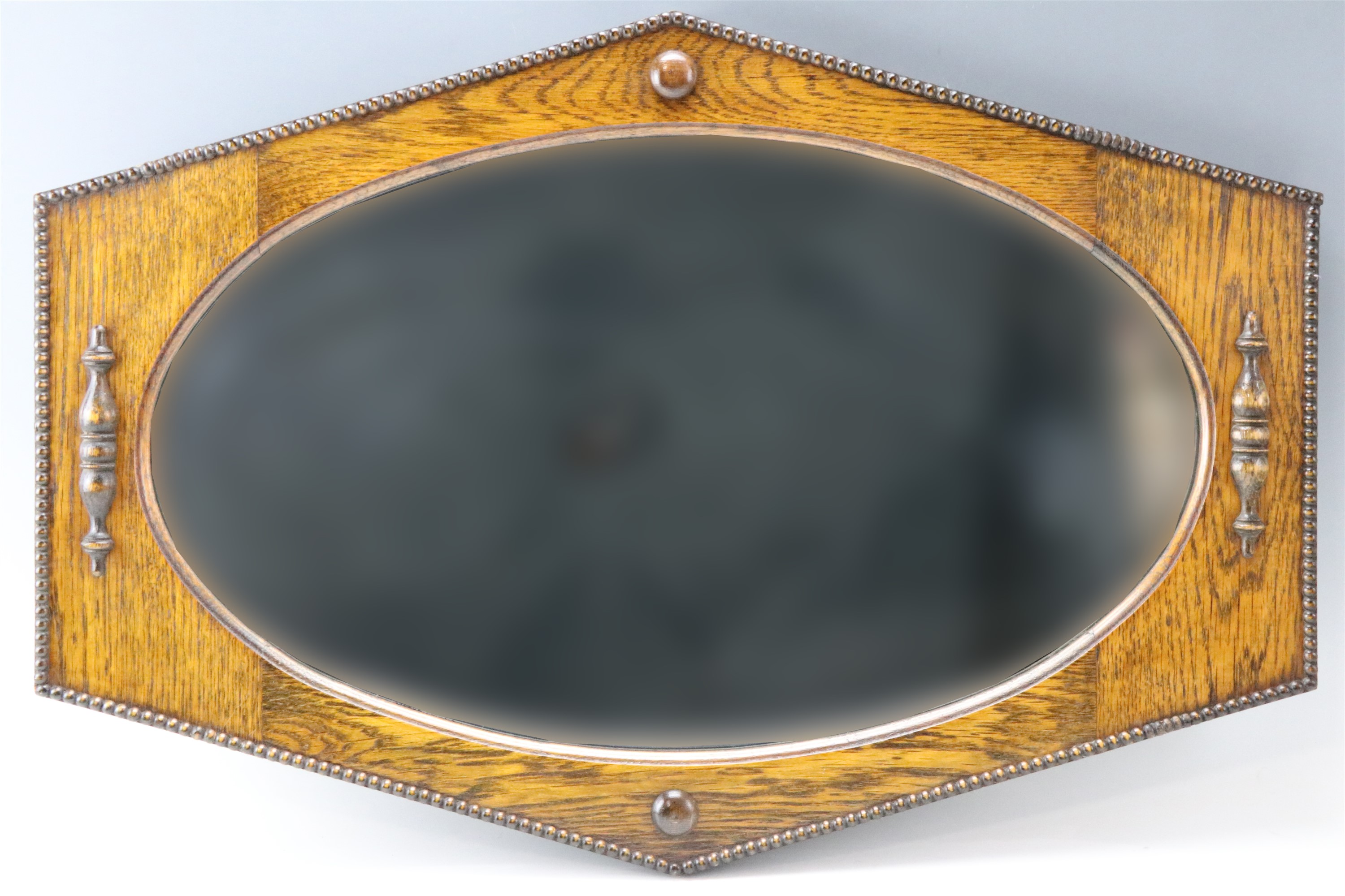 A George V polygonal oak framed wall mirror, 80 cm x 55 cm