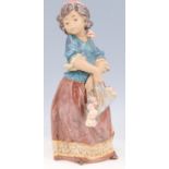 A Lladro figurine, Girl with Flowers, 32 cm