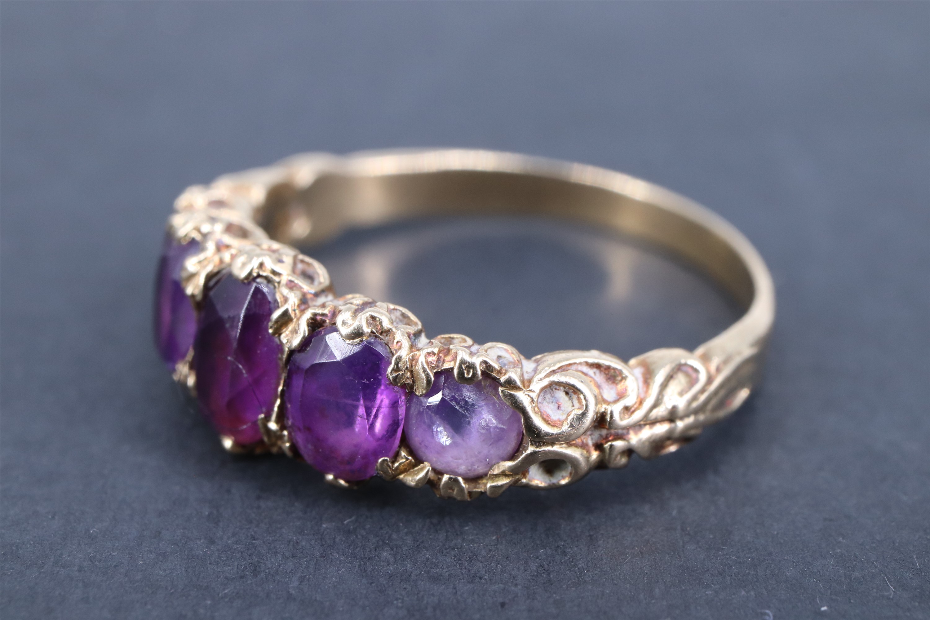 A vintage amethyst finger ring, having five adorsed graduated oval stones, the stiff-leaf - Image 2 of 3