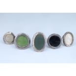Five George V / George VI diminutive silver faced photograph frames, comprising three circular and