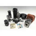 A Pentax ME Super film camera together with a Kodak Brownie Flash II, a Bolex C8SL cine camera, an
