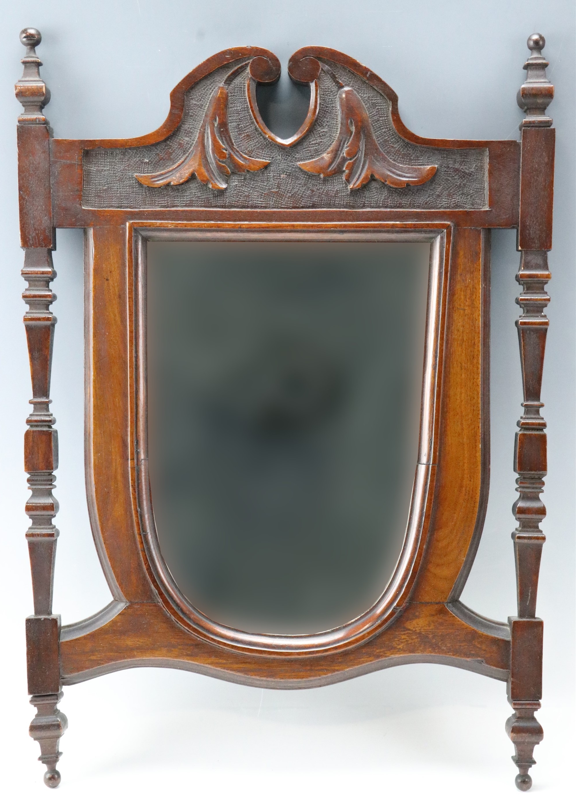 A Victorian mahogany-framed shield-shaped wall mirror, 52 cm x 37 cm