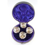 An Edwardian cased set of four salt cellars with spoons, (one spoon a/f), 168 g silver