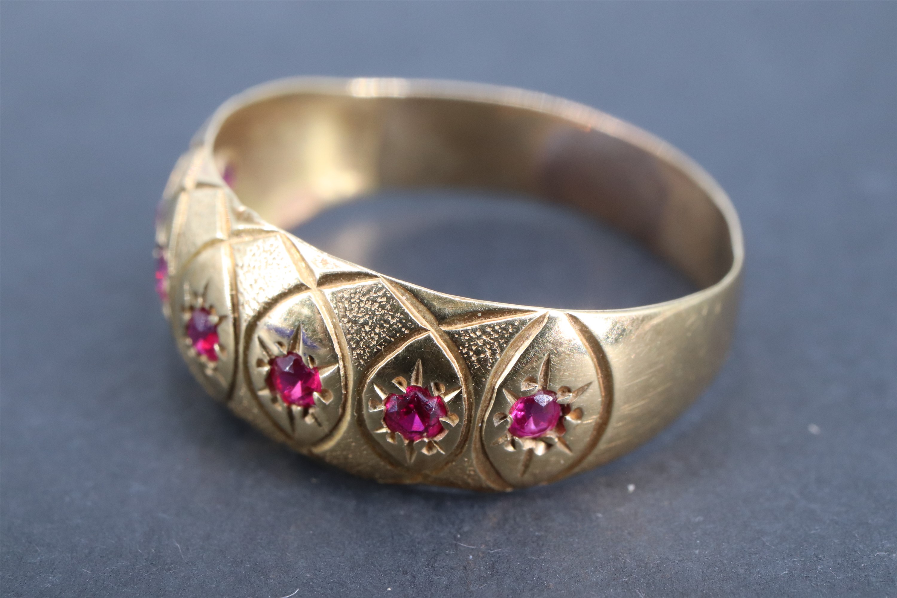 A vintage ruby and yellow metal finger ring, the convex adorsed tapering band gypsy-set with a - Image 2 of 2