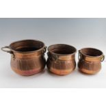 Three graduated copper cachepots, largest 27 x 21 cm