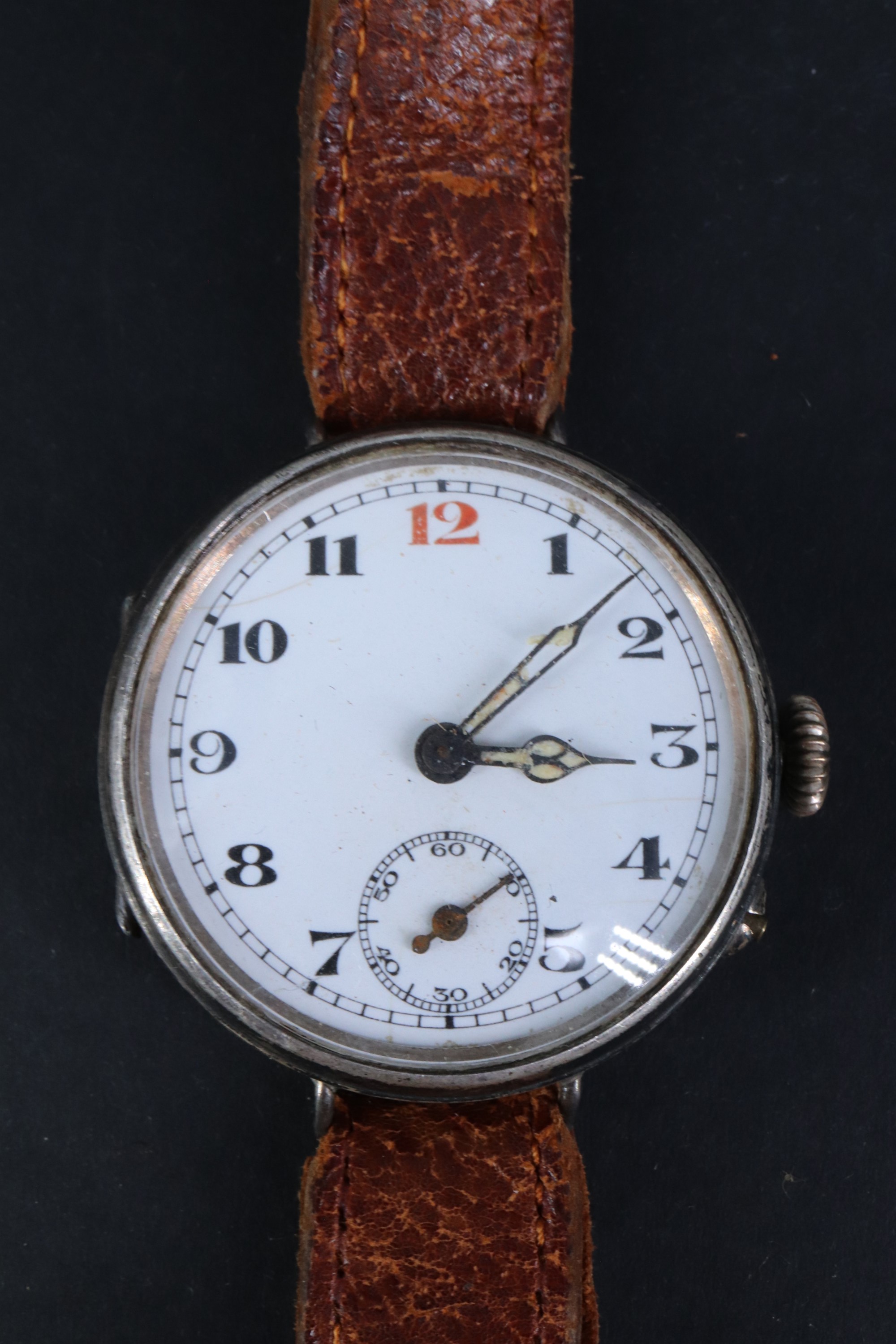 A Great War silver trench watch, having a Swiss pin-set movement and enamel face with "red 12",
