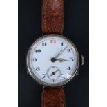 A Great War silver trench watch, having a Swiss pin-set movement and enamel face with "red 12",