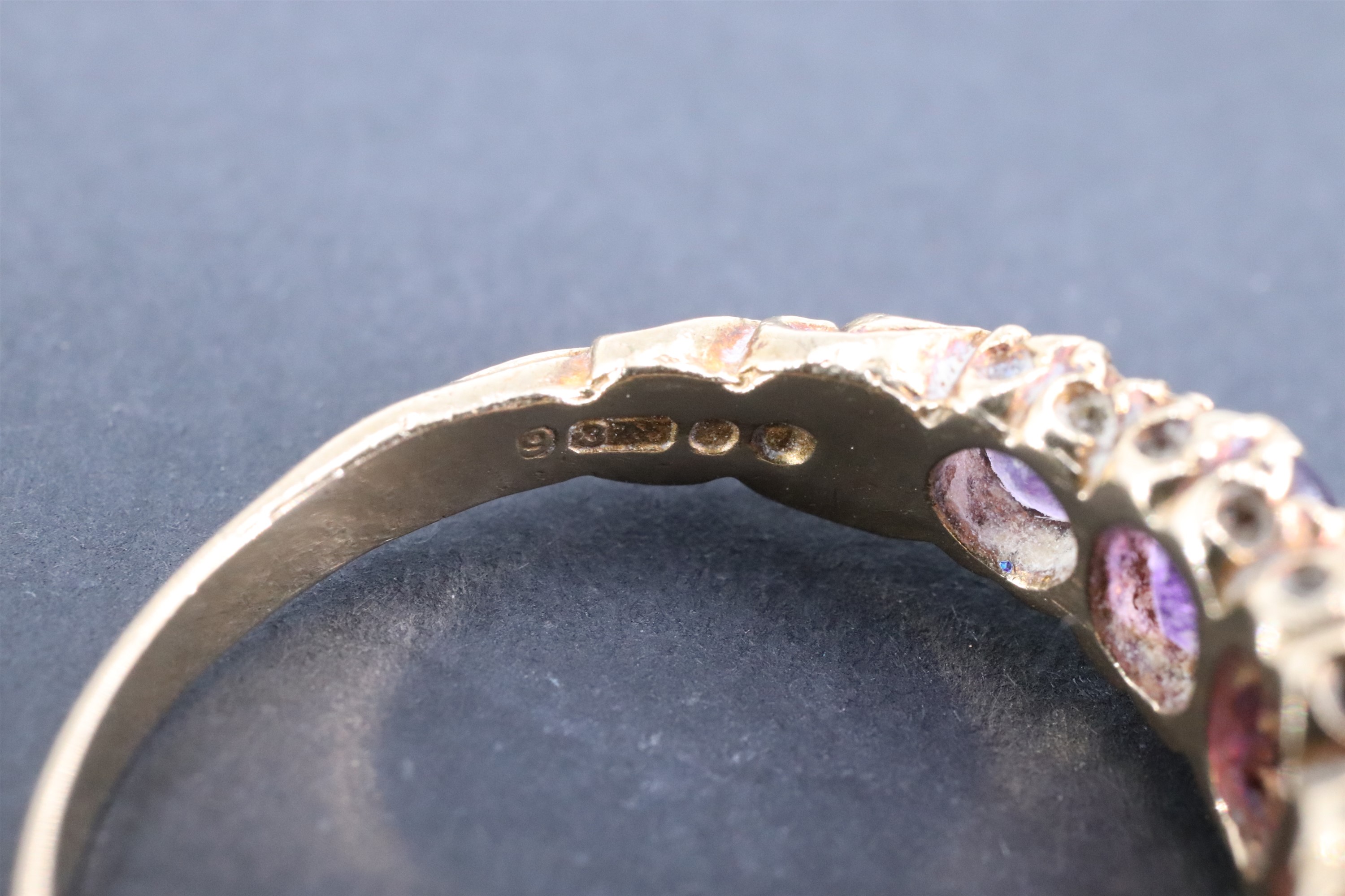 A vintage amethyst finger ring, having five adorsed graduated oval stones, the stiff-leaf - Image 3 of 3