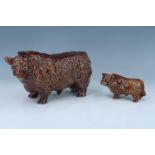 Two highland cow ceramic decanters, tallest 14 cm