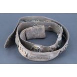 A Great War belt strap bearing a number of Victorian and later British and other badges