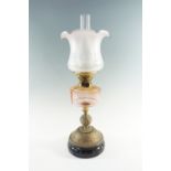 A Victorian and later brass and glass oil lamp, having a peach coloured font, a duplex coronet