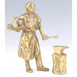 A 20th Century cast brass figure of a blacksmith at his anvil, 18 cm