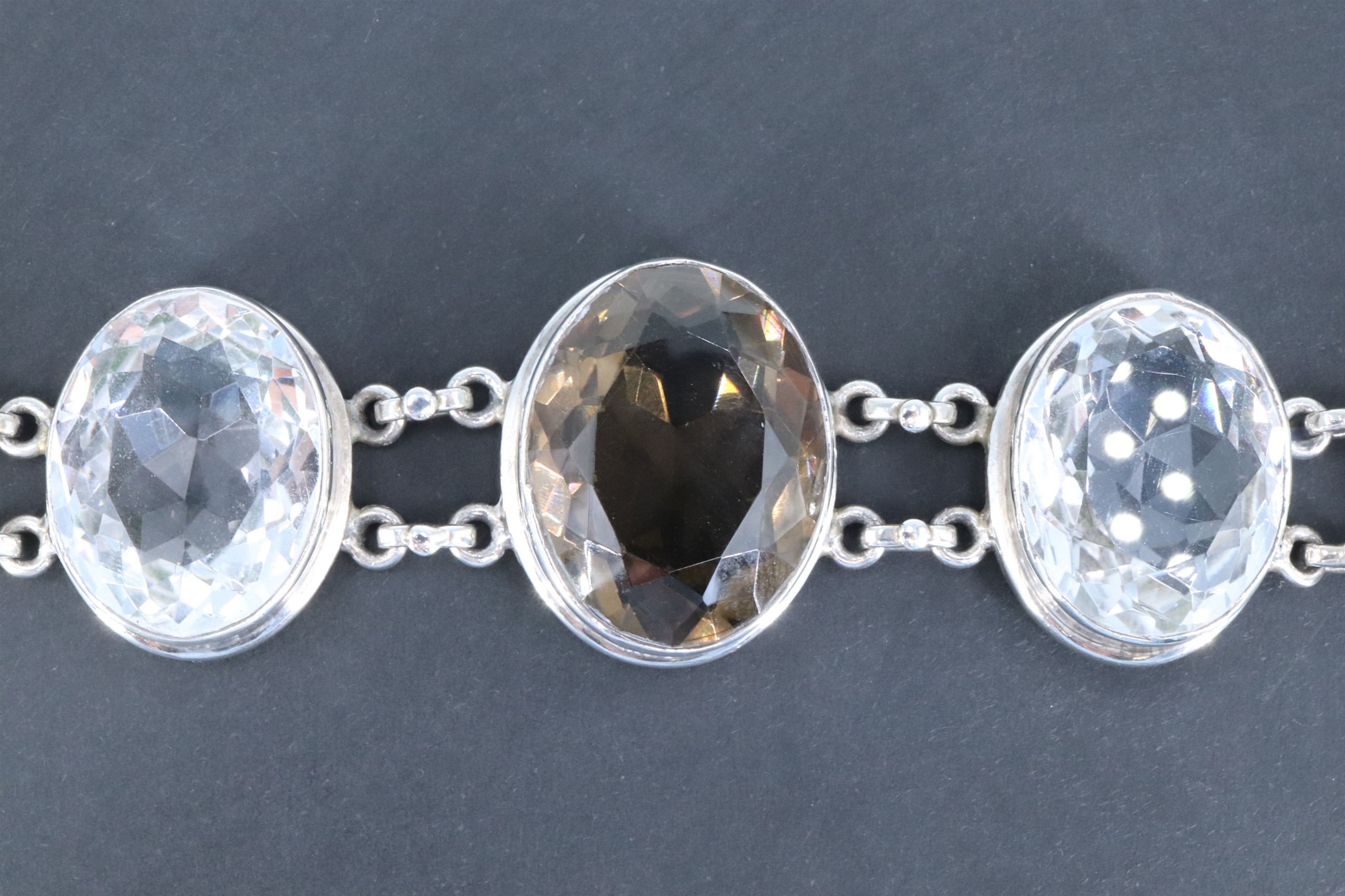 A contemporary white metal bracelet of large facet-cut oval smoky quartz and rock crystal jewels, - Image 2 of 4