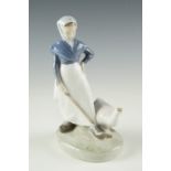 A Royal Copenhagen figurine of a girl with a goose, model number 528, incised signature to base