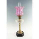 A Victorian columnar brass and cut glass oil lamp, having a duplex coronet burner and crinoline