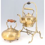 An early 20th Century glass handled brass teapot, together with a spirit kettle (lacking burner)