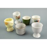 A large quantity of ceramic and glass egg cups