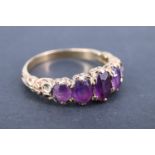 A vintage amethyst finger ring, having five adorsed graduated oval stones, the stiff-leaf