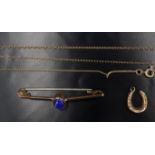 An early 20th Century 9 ct yellow metal bar brooch, set with a lapis lazuli cabochon, marked '9c', a
