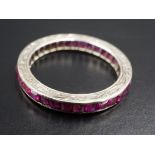 A ruby and precious white metal eternity ring, the square-cut stones channel-set and of 2 ct