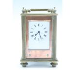 An early 20th Century French brass and copper carriage clock, having a keyless wind, key set