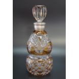 A Bohemian style amber flashed and cut glass spirit decanter, of waisted from with white metal