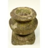 An early 20th Century carved stone urn and a cast concrete capital, urn 25 cm high