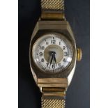 A 1940s Rotary wristlet watch, having a 15 jewel movement in a 9 ct gold tonneau case, on a gilt