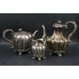 An early Victorian silver part tea set, comprising a teapot, coffeepot and cream jug of lobed form