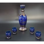A 1930s Venetian silvered and cobalt blue flashed glass liqueur set, decorated in depiction of