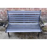 A cast iron garden bench, having wooden slats, approximately 120 x 65 x 78 cm