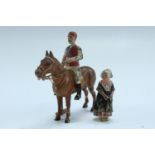 Two cold painted bronze figures, comprising a mounted polo player and a Dutch woman in costume, polo