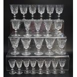 Three sets of eight cut crystal wine glasses, tallest 11.5 cm, (together with spares)