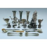 A quantity of electroplate, including a sugar caster, spill vases, egg cups, miniature figurines,