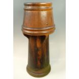 A vintage salt-glazed earthenware chimney pot, of cylindrical section with a wind cowl top by J
