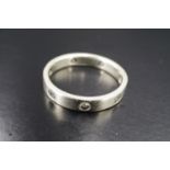 A contemporary diamond and 9 ct white gold eternity ring, comprising a rectangular section band
