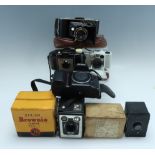 A Nikon F70 camera body together with a group of vintage cameras, including a Minox 35 AL, a boxed