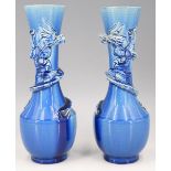 A pair of Victorian aesthetic period blue faience earthenware majolica dragon vases, Burmantofts