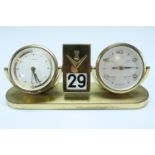 A 1960s gilt metal desk alarm clock, calendar and barometer by Europa, comprising a keyless wind and