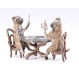 A cold painted bronze figure of two pug dogs sitting at a table playing cards by Bergman,