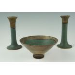 A late 20th Century Japanese influenced stoneware bowl and a pair of candlesticks, in mottled