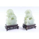A pair of Chinese jade temple guardians, 14 cm high (on plinth)