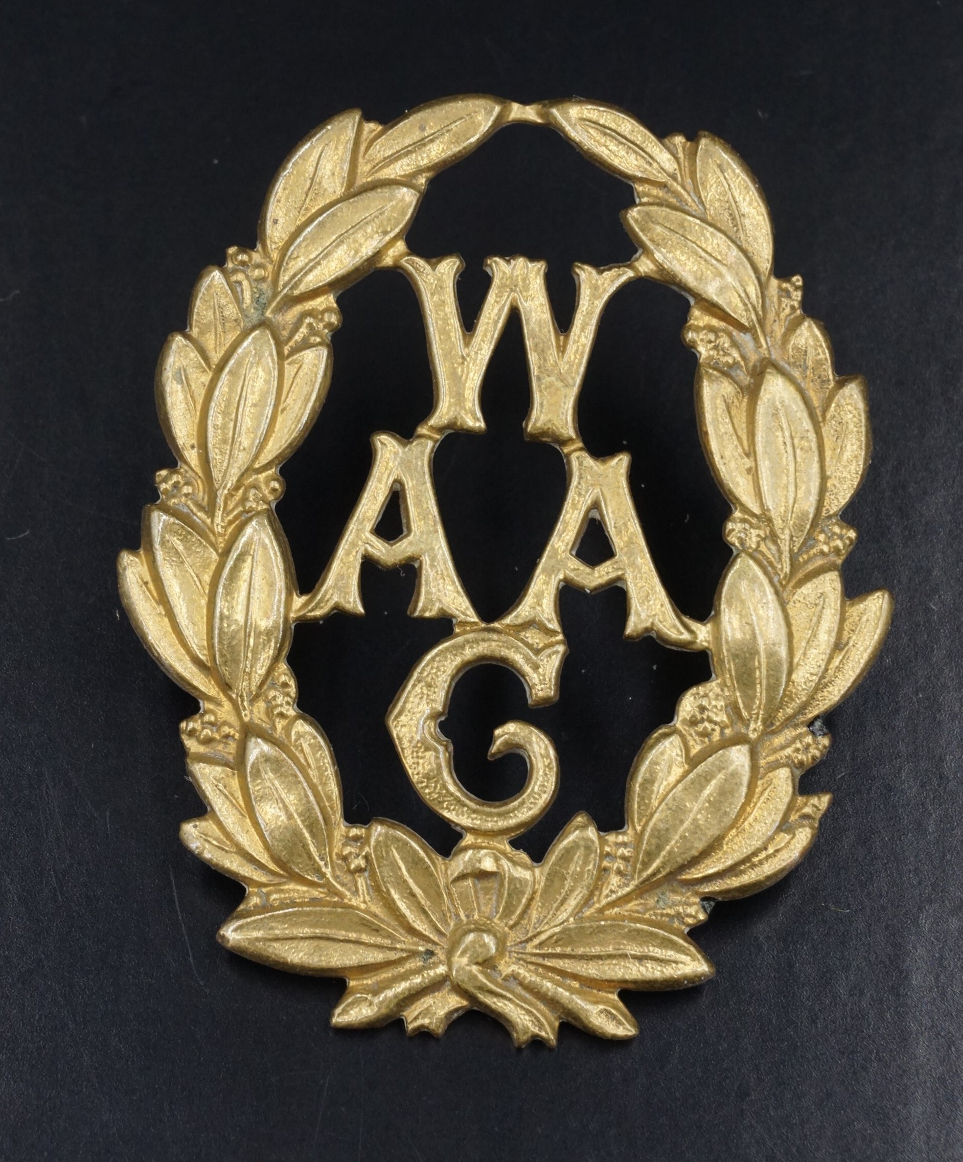 A Great Women's Army Auxiliary Corps cap badge by Gaunt and bearing a numbered plaque verso