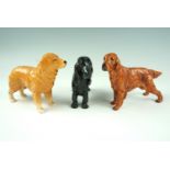 Three Royal Doulton and Beswick dogs, comprising a Golden Retriever, a Cocker Spaniel and a Setter