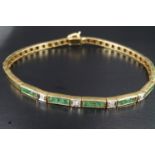 A late 20th Century emerald and diamond tennis bracelet, comprising five box links, each channel set