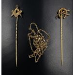 Two vintage yellow metal stick pins, being Masonic and equestrian, having a crop and a horseshoe,